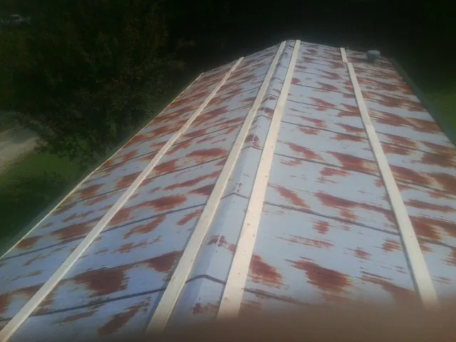 Rusted metal roof panels with new wood purlins before replacement — Storm Damage Roof Repair in Pawhuska by Roofing Brothers