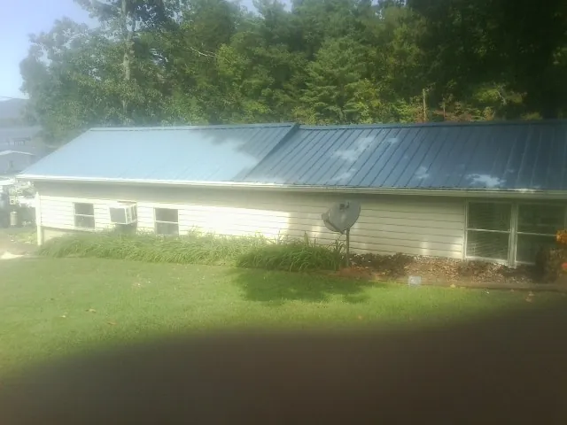Blue metal roof running the length of a single story home in Pawhuska